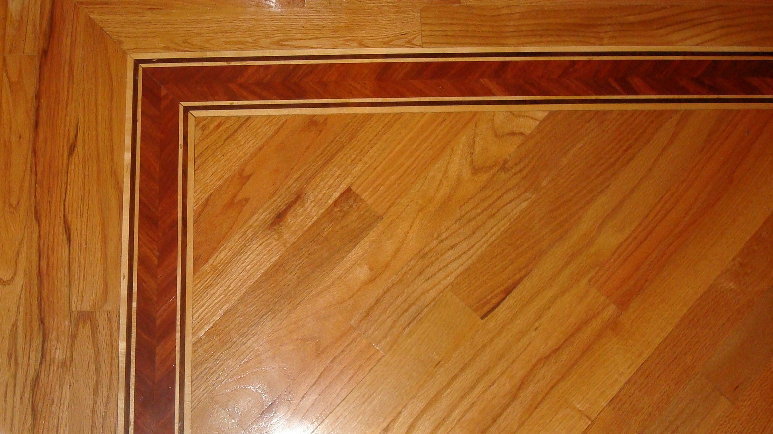 Close-up of a wooden floor with a visible border