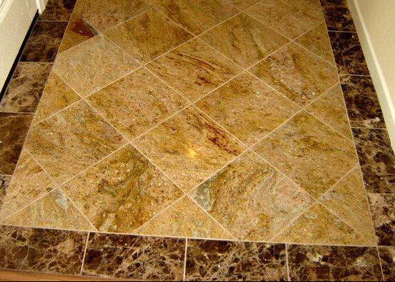 Brown diamond-patterned tiles on a floor with white baseboards.